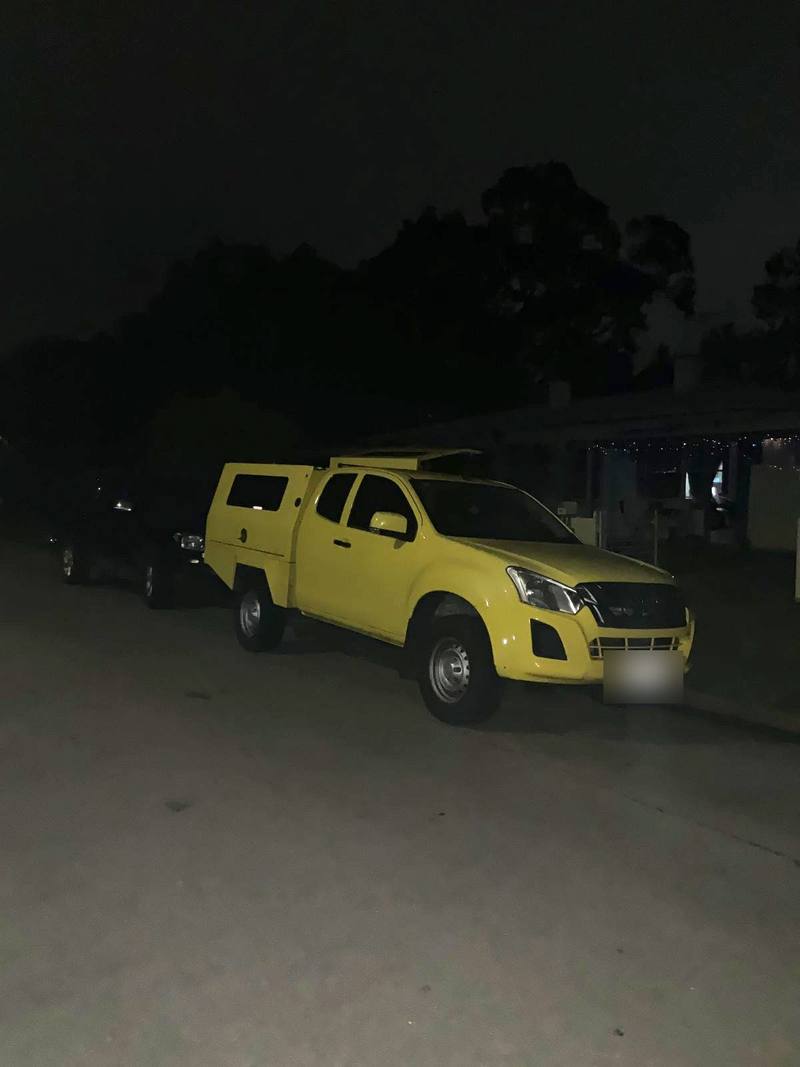 Yellow service ute parked on a suburban street at night, Elizabeth South