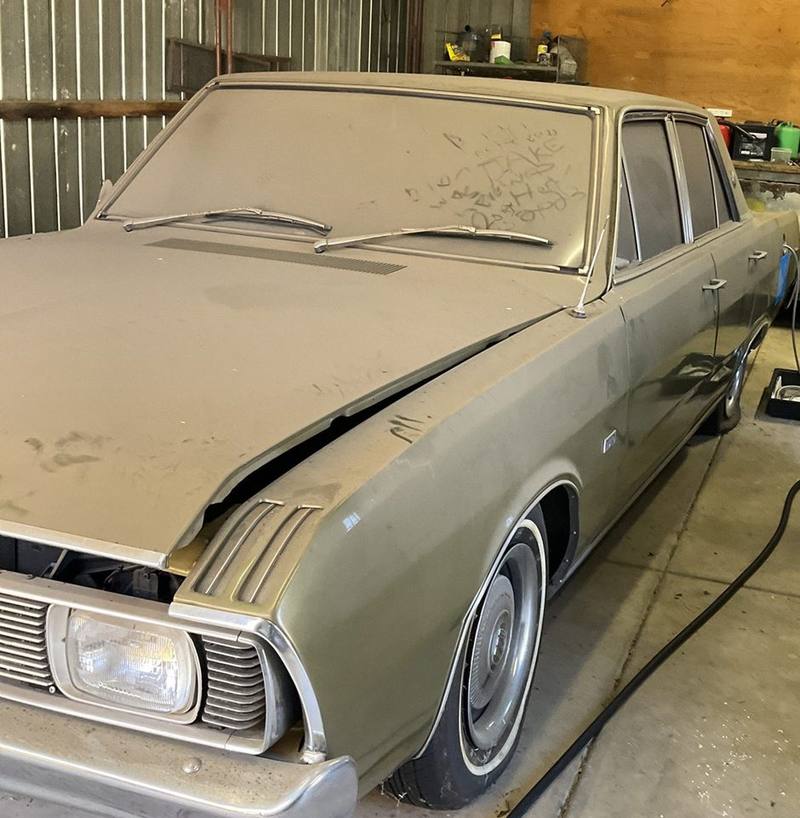 Dusty 1971 Chrysler Valiant sedan parked in a corrugated iron shed, Woodville West
